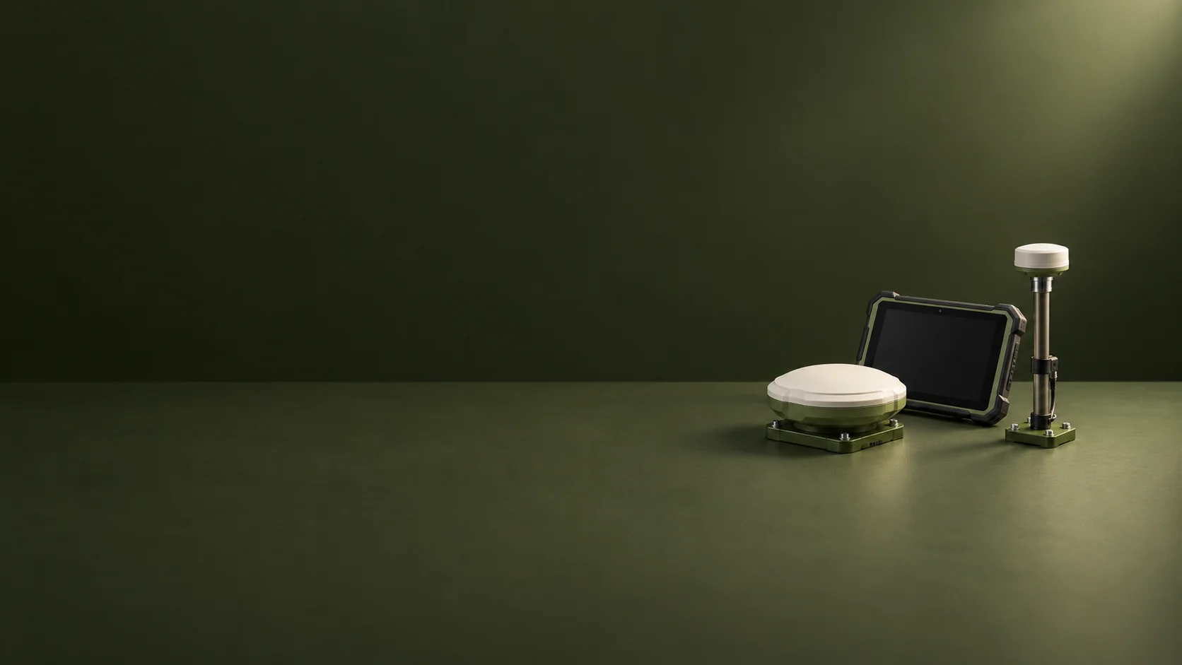 A GNSS receiver, inactive rugged tablet and sensor mast on a dark olive table.