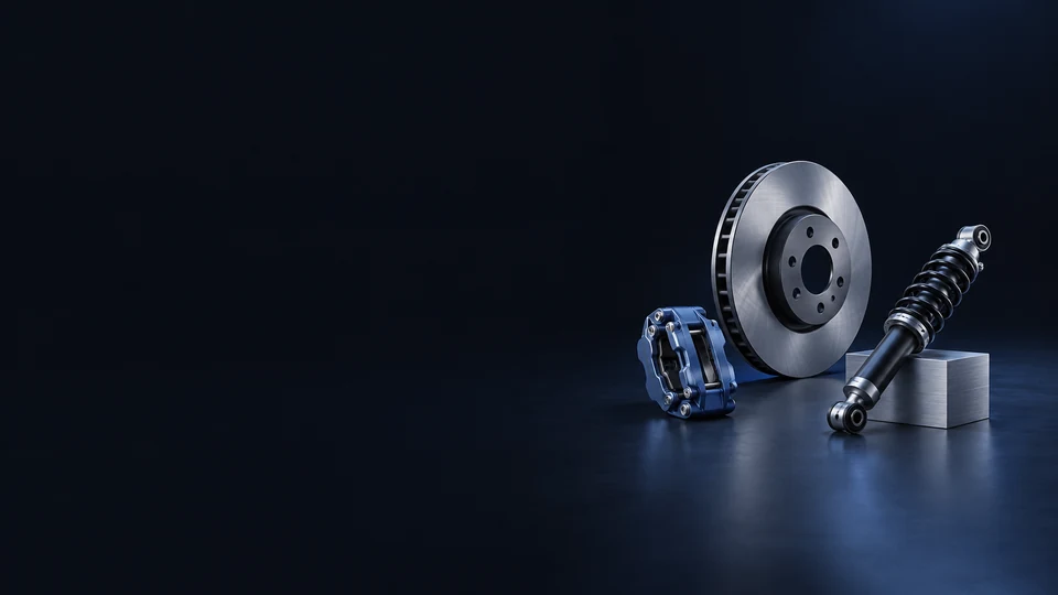 A ventilated brake rotor, blue caliper and coilover damper beside a machined aluminum support.
