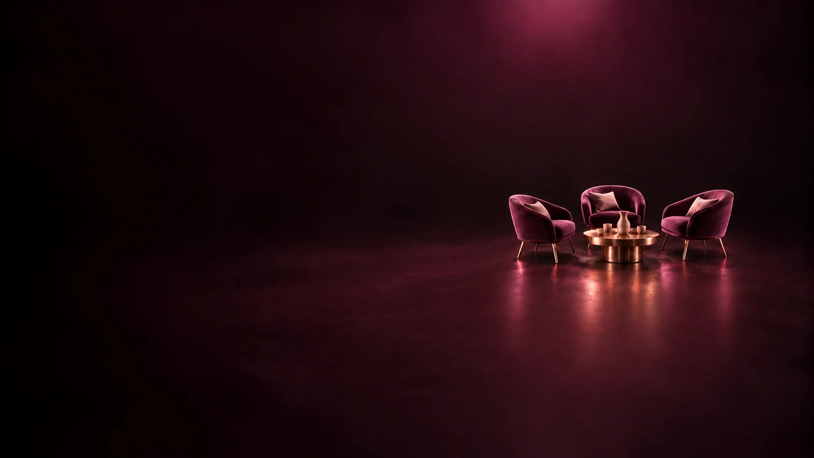Three empty curved lounge chairs around a small round table.