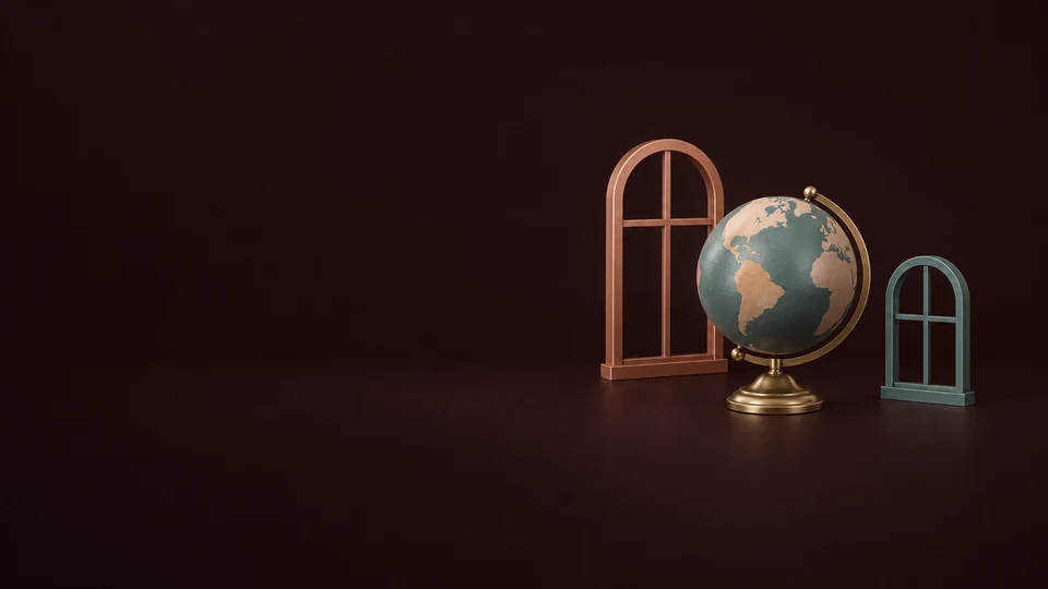 A small globe between two empty copper and teal window frames.