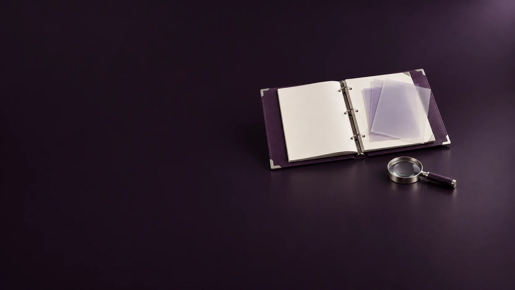 An open purple report binder with blank pages, translucent overlays and a silver magnifying glass.