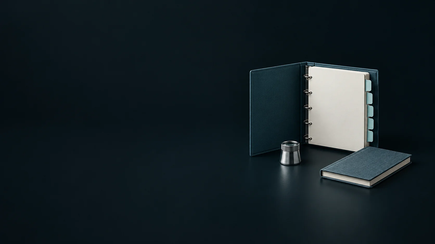 A blank blue-green audit binder with pale tabs, a silver loupe and a closed notebook.