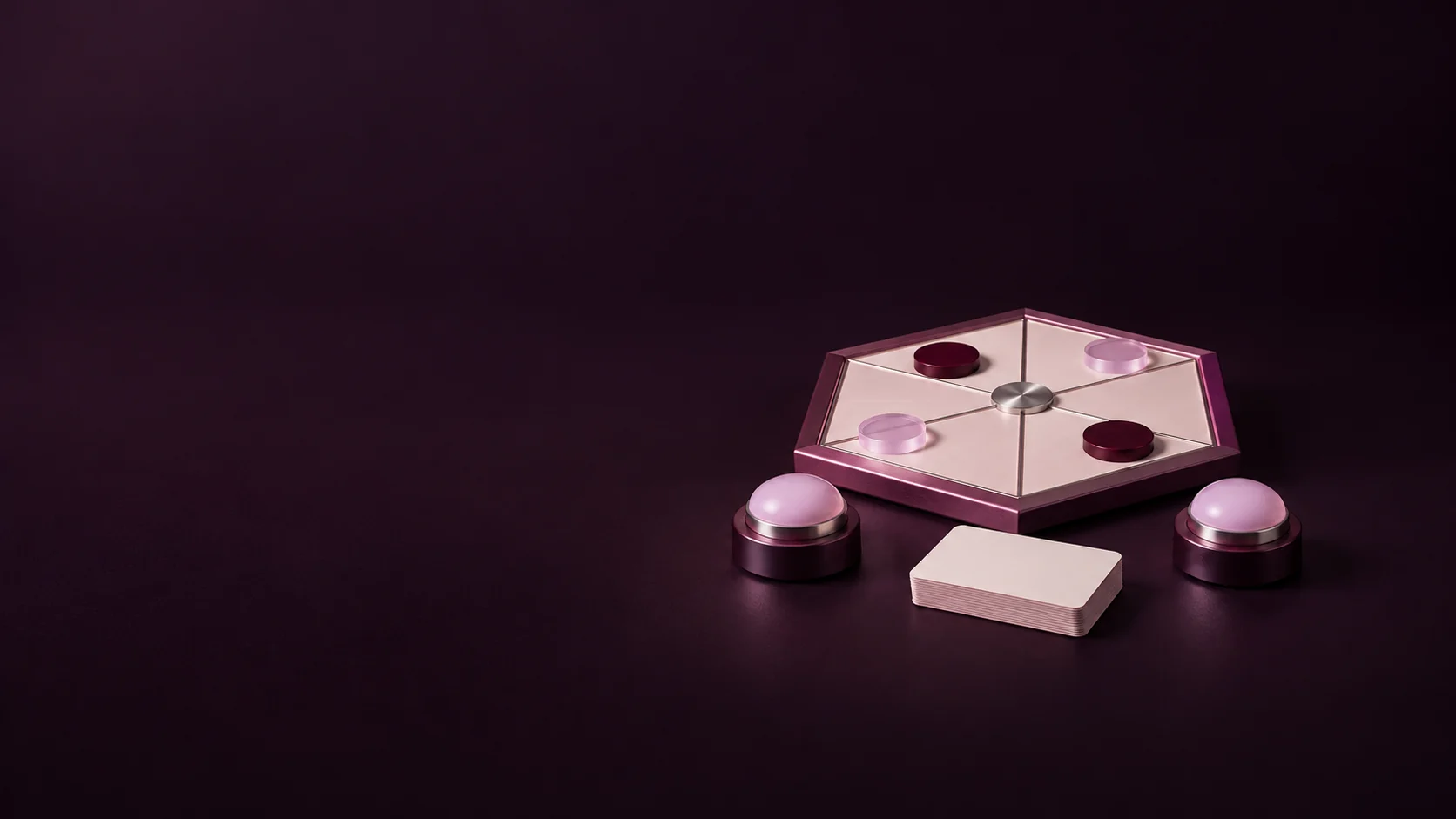 A hexagonal activity board with unmarked tokens, two tabletop buzzers and a blank card deck.