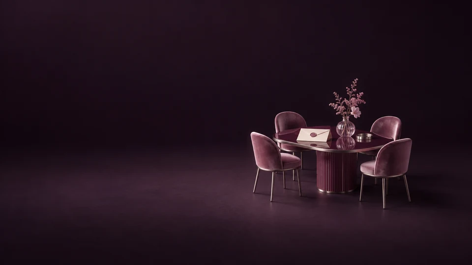 A miniature oval gathering table with four chairs, a blank invitation and a glass floral vase.