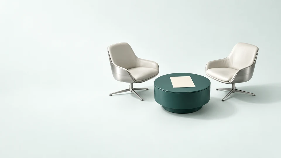 Two miniature consultation chairs around a low teal table with a blank planning sheet.