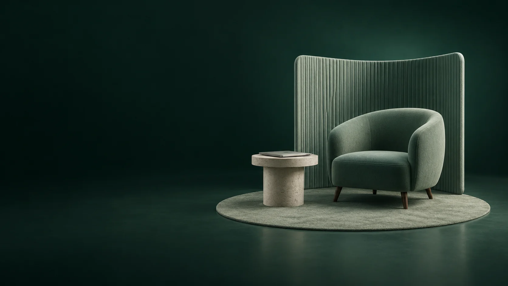 An empty sage armchair sits beside a stone table with a closed laptop in front of a ribbed textile panel.