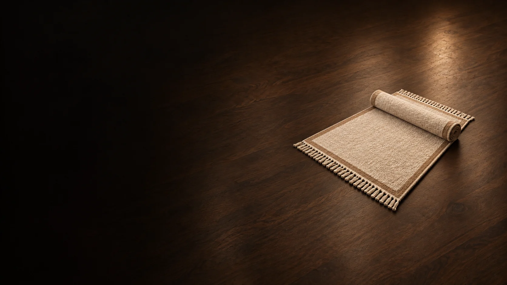 Oatmeal wool rug with camel edging and one loosely rolled end.