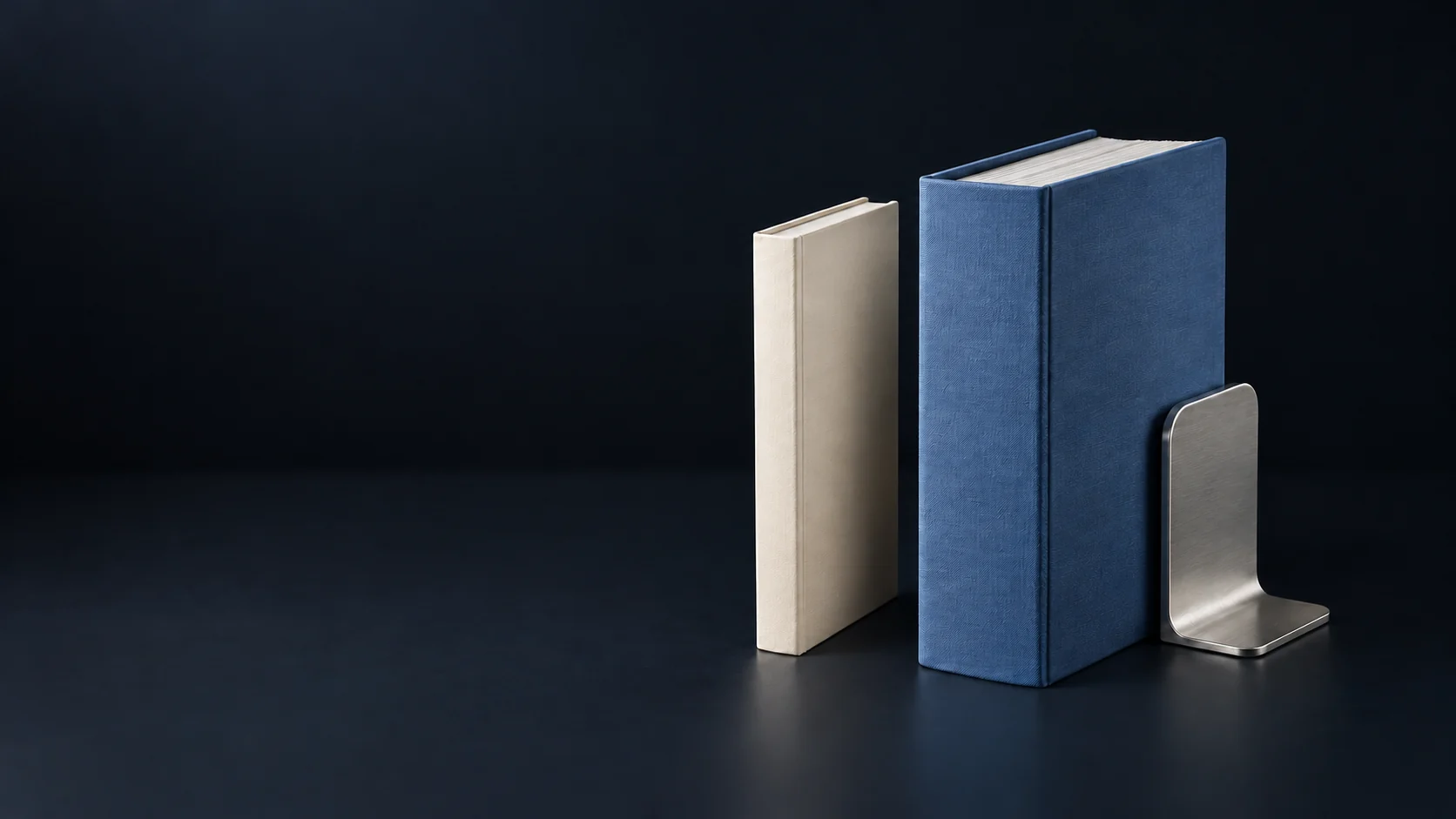 A slim ivory consultation folio beside a deep blue litigation binder and silver bookend.