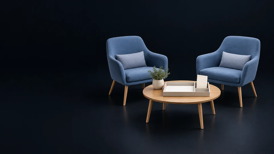 Two empty blue consultation chairs facing a low table with a blank intake tray and separate envelope.