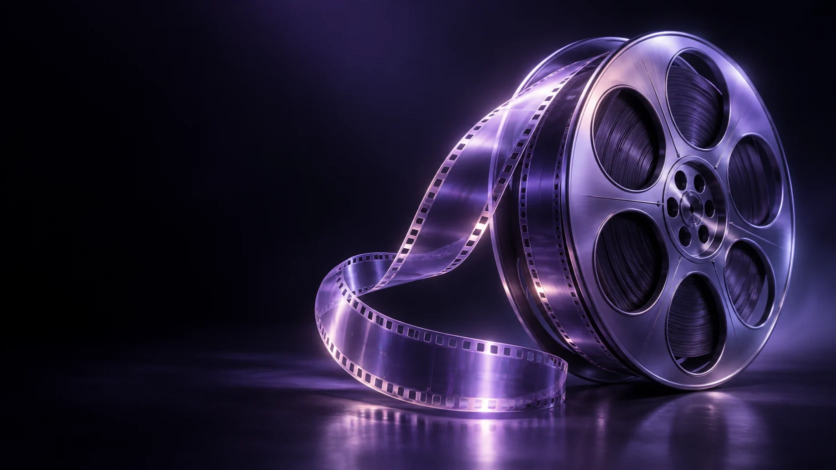 A violet metal film reel with a translucent film strip curling across a dark surface.
