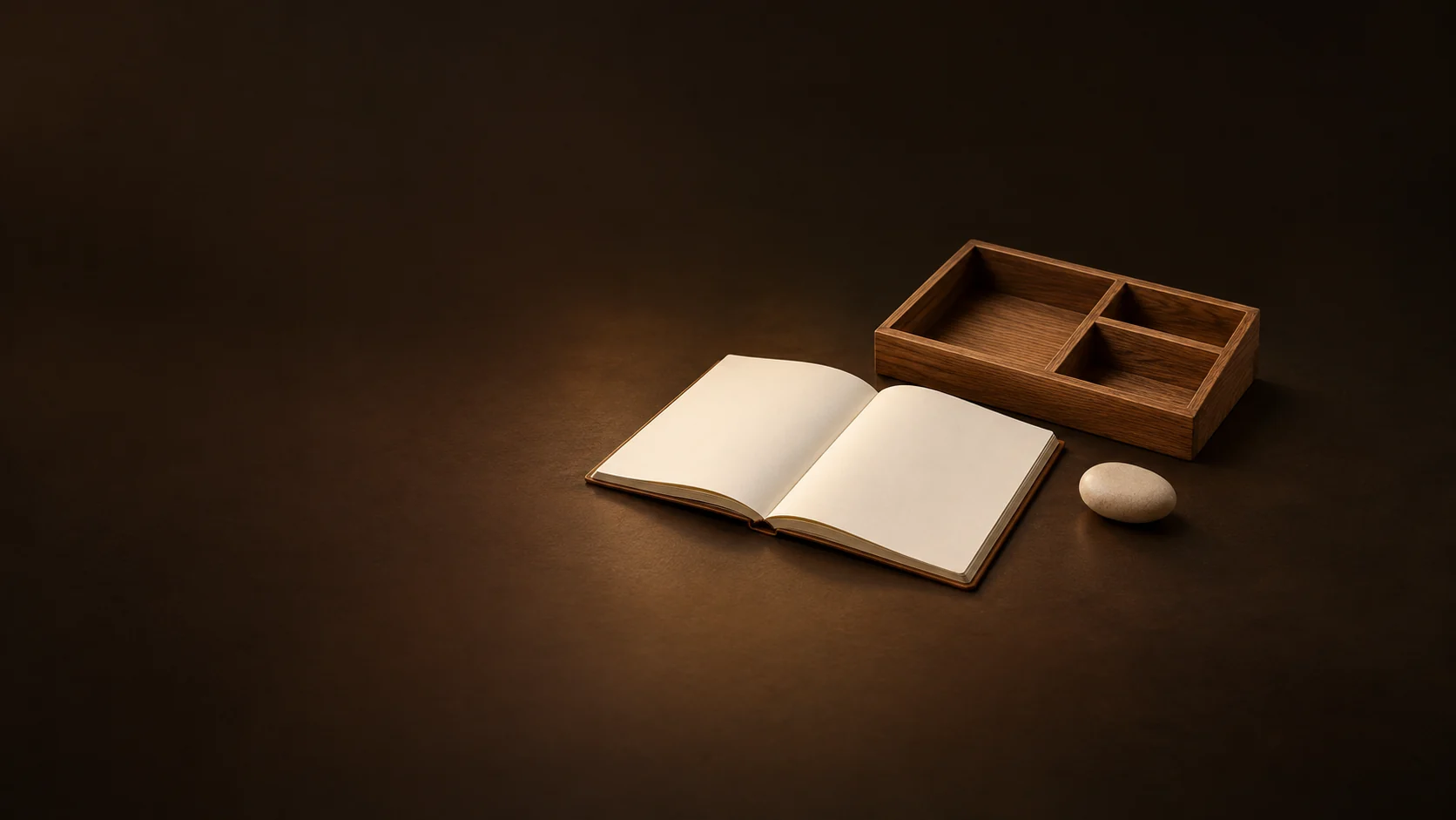 Open blank task notebook, compartmented oak organizer and appointment pebble.
