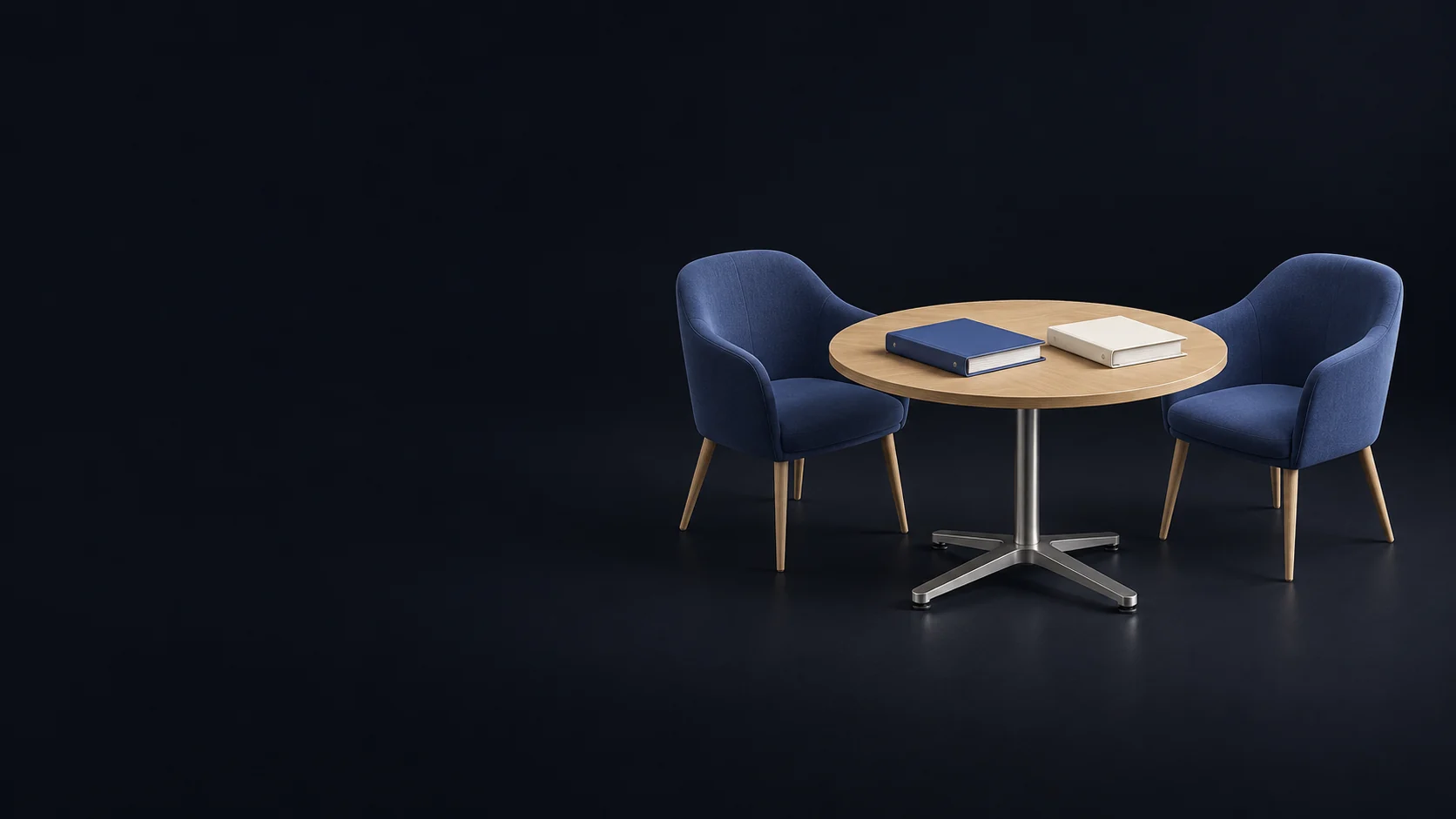 Two empty indigo chairs around a complete round oak seminar table with separate blank indigo and ivory binders.