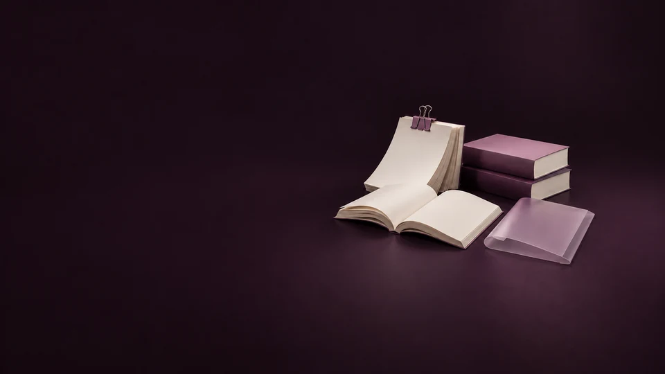 A clipped blank manuscript, open paperback and two closed copies sit beside a translucent proof sleeve.