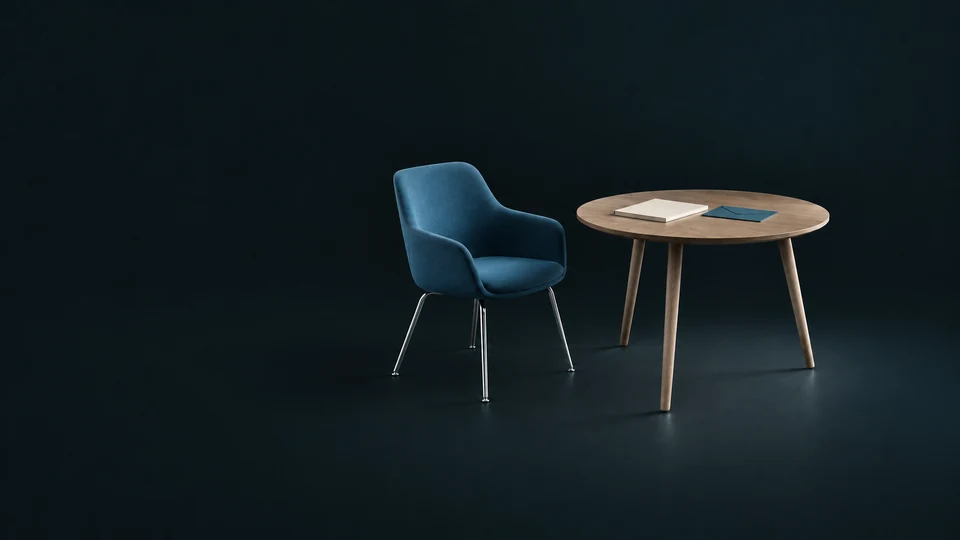 An empty blue chair beside a wooden interview table with a blank folio and envelope.