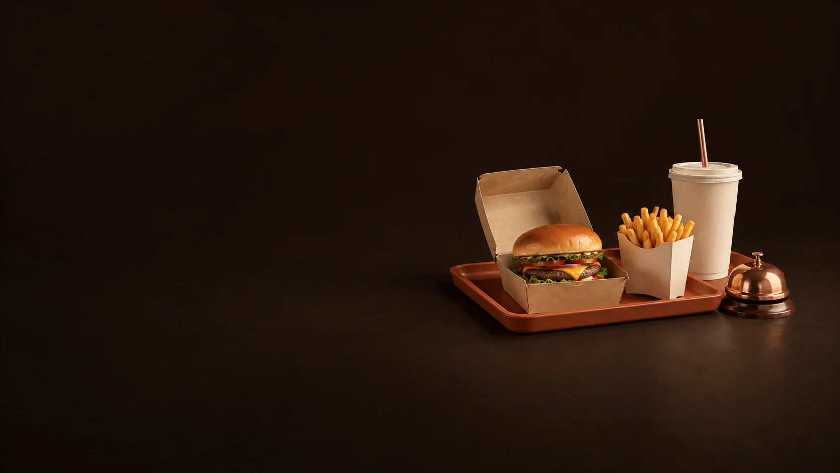 Burger, fries and takeaway drink on a terracotta tray beside a copper pickup bell.