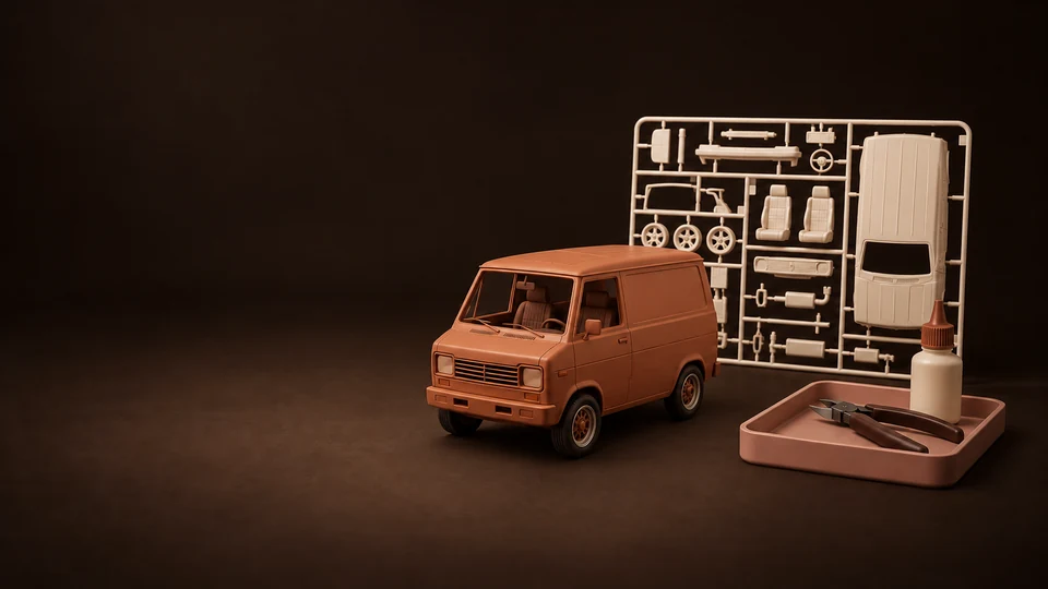 An assembled utility-vehicle scale model beside a complete parts sprue, adhesive bottle and nippers in a tray.